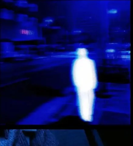 Blurred Figure in Blue Light